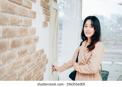 Young Woman Leaving Home With Smile