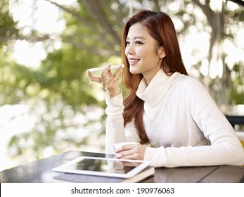 young woman leaving voice message using mobile phone.