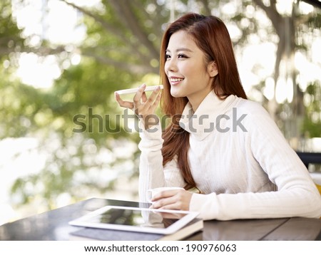 young woman leaving voice message using mobile phone.