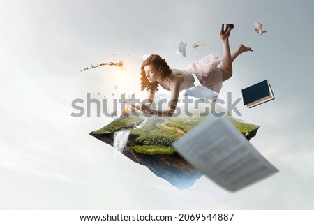 Young woman levitates while reading a book