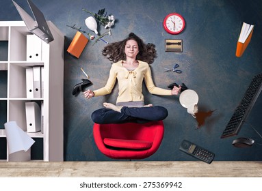 Young Woman Levitating By A Yoga Pose In The Office