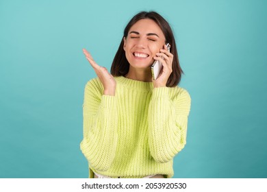 Young Woman In Light Green Sweater With Mobile Phone Having Conversation Listen Audio Message Happy Excited Winner Yay