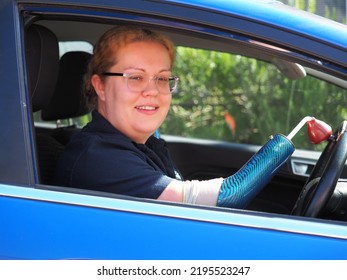 Young Woman With Limb Deformity Driving To Work