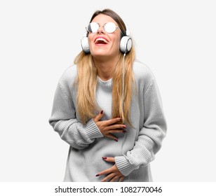 Young woman listen to music with headphone confident and happy with a big natural smile laughing