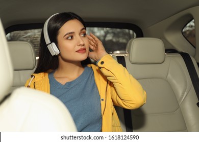 Young Woman Listening To Audiobook In Car