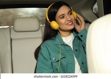 Young Woman Listening To Audiobook In Car