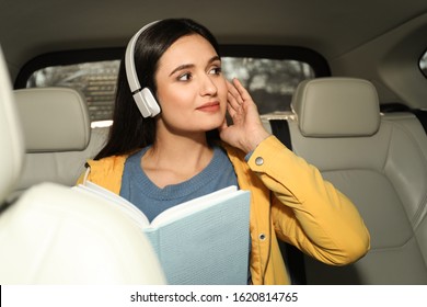 Young Woman Listening To Audiobook In Car