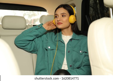 Young Woman Listening To Audiobook In Car