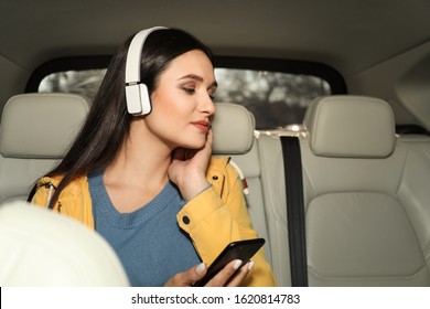 Young Woman Listening To Audiobook In Car