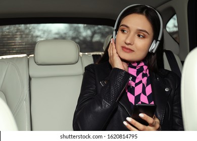 Young Woman Listening To Audiobook In Car