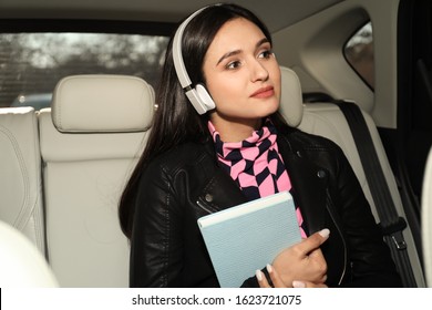 Young Woman Listening To Audiobook In Car