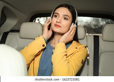 Young Woman Listening To Audiobook In Car