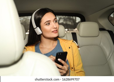 Young Woman Listening To Audiobook In Car