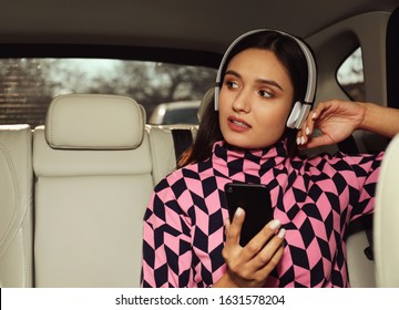 Young Woman Listening To Audiobook In Car