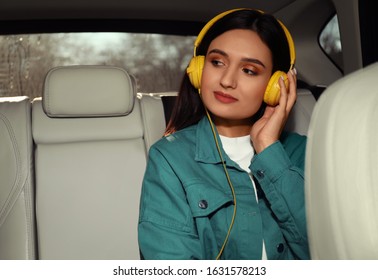 Young Woman Listening To Audiobook In Car