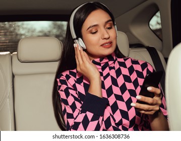 Young Woman Listening To Audiobook In Car