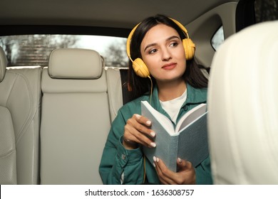 Young Woman Listening To Audiobook In Car