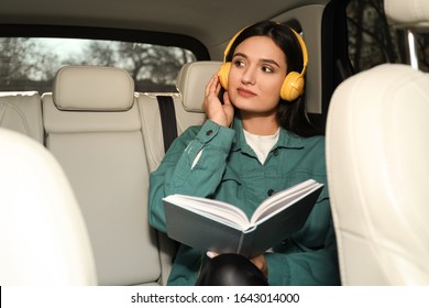 Young Woman Listening To Audiobook In Car