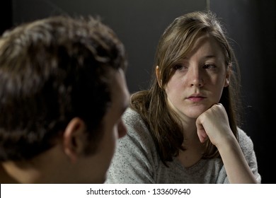 Young Woman Listening To Man's Testimony At A Support Group