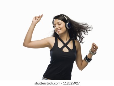 Young Woman Listening To Music And Dancing