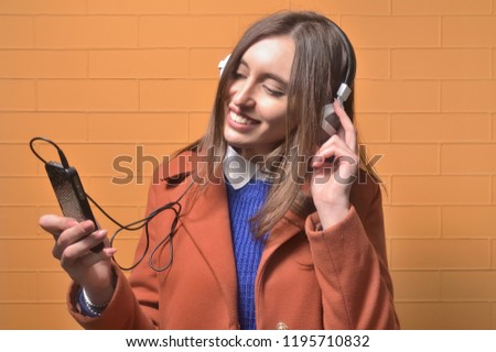 Young woman listening to the music from a smart phone