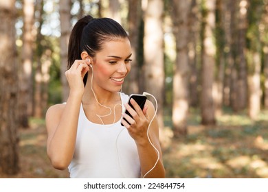 Young Woman Listening To Music Through Earbuds