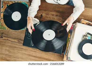 Young Woman Listening To Music From Vinyl Record Player. Playing Music On Turntable Player. Female Enjoying Music From Old Record Collection At Home. Stack Of Analog Vinyl Records. Retro And Vintage