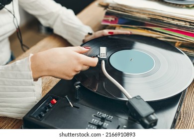 Young Woman Listening To Music From Vinyl Record Player. Playing Music On Turntable Player. Female Enjoying Music From Old Record Collection At Home. Stack Of Analog Vinyl Records. Retro And Vintage