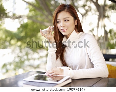 young woman listening to voice message using mobile phone.
