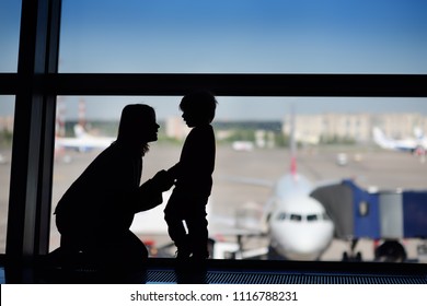 Young Woman With Little Boy Having Fun At The International Airport. Mother With Her Cute Little Son Waiting Boarding. Family Travel Or Immigration Concept