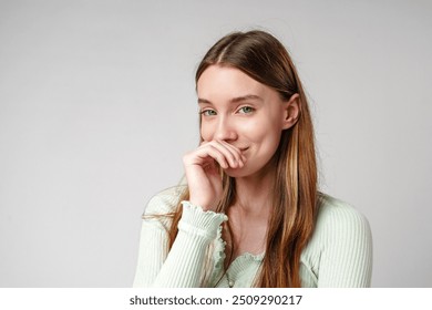 Young Woman With Long Brown Hair Smiles Shyly While Covering Her Mouth With Her Hand - Powered by Shutterstock