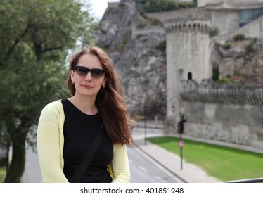 Young Woman With Long Brown Hair In Dark Glasses In The Ancient French Town