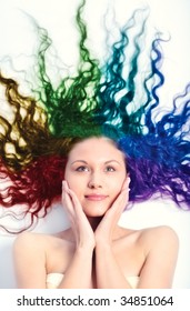 Young Woman With Long Curly Hair. Rainbow Colored Hair.