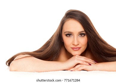 A Young Woman With Long Strait Hair Poses On A White Background