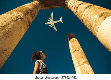  Young woman look at airplane dreaming about vacation. Explore the world. Export concept. Time to travel. Freedom life. Independent person. Tourism and transportation industry. Spirit of adventure.