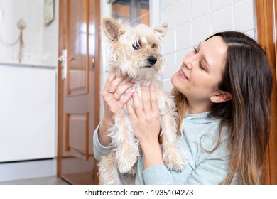 Young woman look at her dog at home