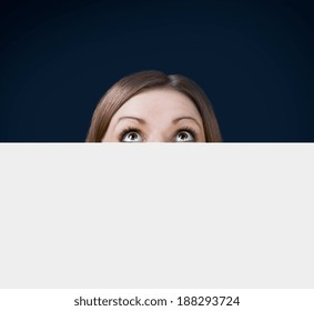 the young woman looked up from behind the Billboard  - Powered by Shutterstock