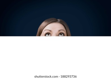 the young woman looked up from behind the Billboard  - Powered by Shutterstock