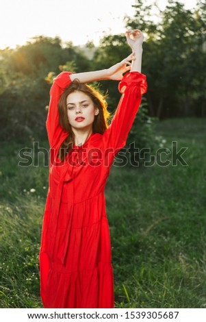 Similar – Portrait of a girl in red dress on a wooden door