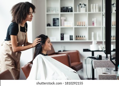 Young woman looking for changes, trying new hairstyle at beauty salon, empty space