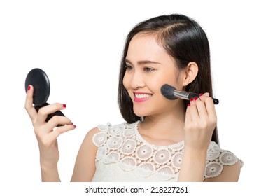 Young Woman Looking At The Compact Mirror And Applying Blush