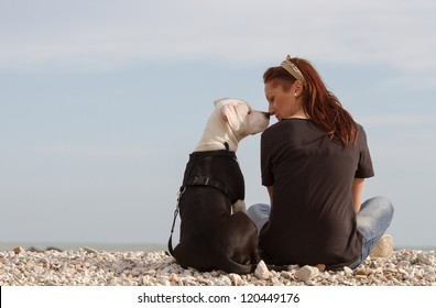 Young woman looking at dog nose to nose