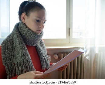 Young Woman Looking The Gas Energy Bill For Home Heating, Gas Crisis 