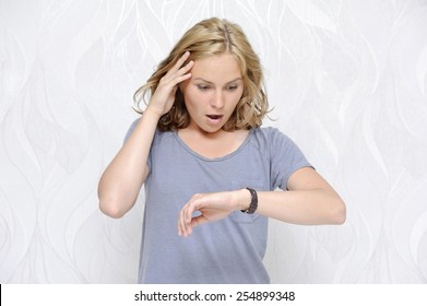 Young Woman Looking At Her Watch Being Late