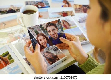 Young woman looking at image prints with her ex-boyfriend at home