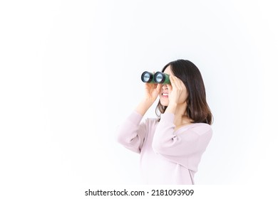 Young woman looking into the distance with binoculars - Powered by Shutterstock