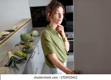 Young Woman Looking Into The Fridge, Feeling Hungry At Night