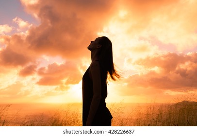 Young woman looking up into the sky. Stress free concept. 