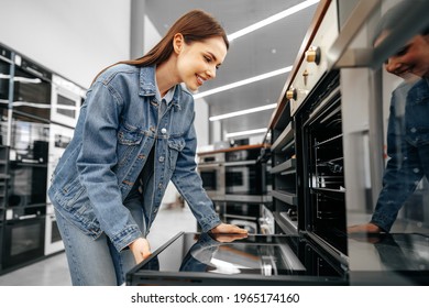 Young woman looking for new electric oven in a shopping mall - Shutterstock ID 1965174160