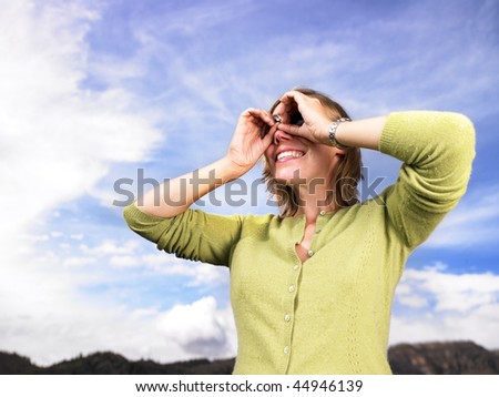 Similar – Junge Frau bedeckt ihr Gesicht vor der Sonne auf einem grünen Feld.